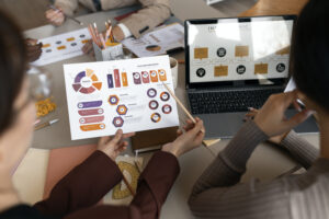 Illustration of digital marketing elements including SEO, social media, email, and mobile marketing icons surrounding a laptop screen with data charts.