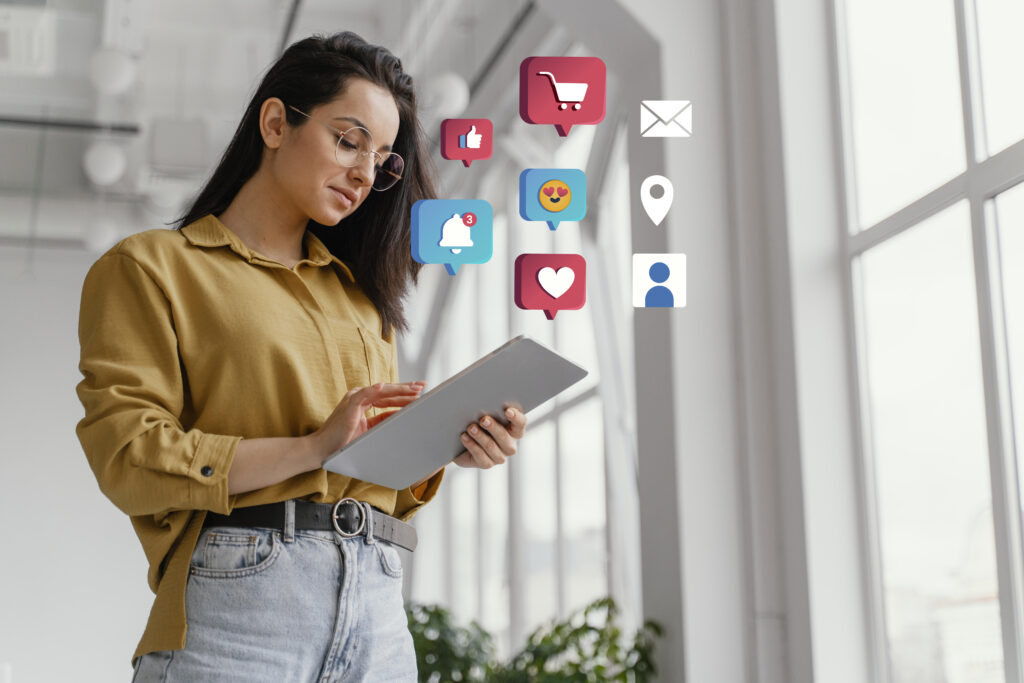 Digital marketer working on laptop with SEO, email, and social media icons